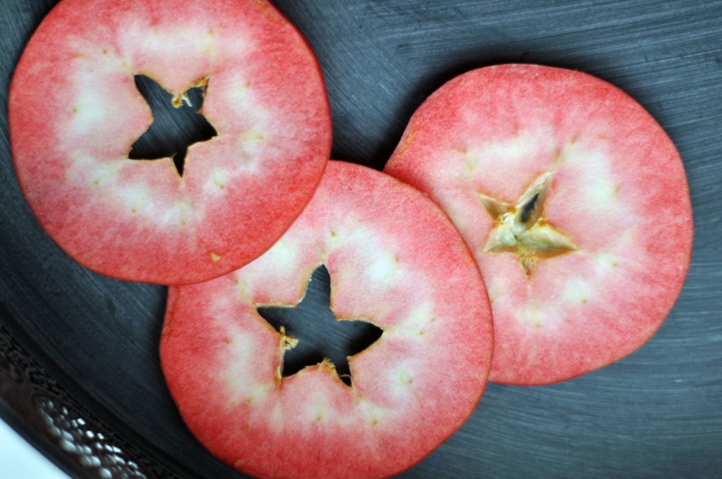 Three Slices of Red Love Apples on a dark background 