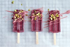 Low Histamine Blackberry Popsicle's decorated with Ruby Chocolate and pistachios